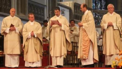 Dekan Helmut Haug (Mitte) überreicht die Ernennungsurkunde an den den neuen Stadtdekan Rauch (2.v.r.)